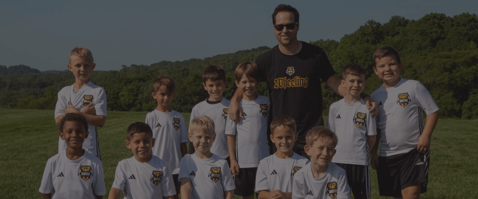 WASA boys posing for team photo with coach