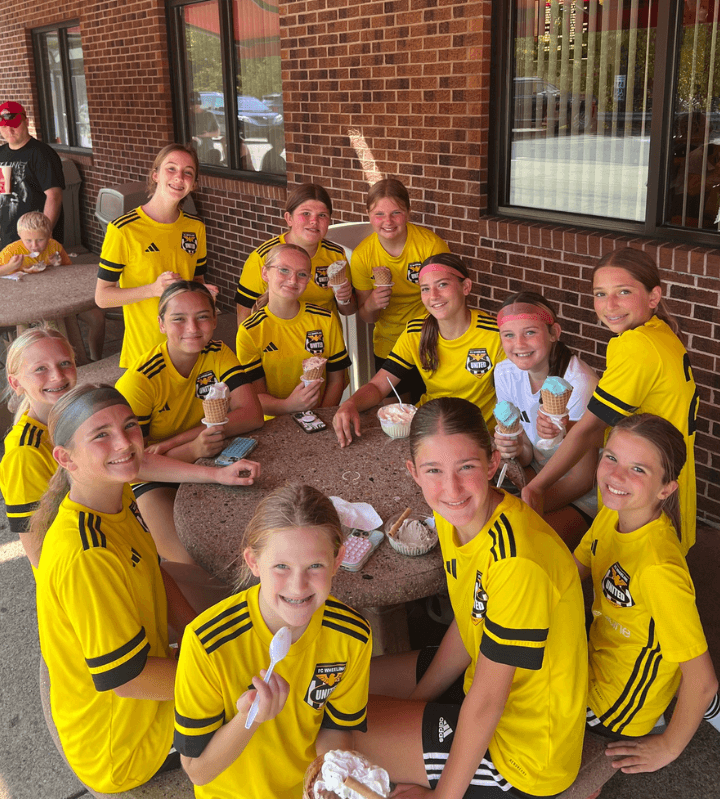 yellow soccer team having ice cream